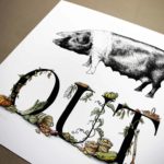 Print of a saddleback pig above bold black lettering decorated with vegetables growing around and beside the letters