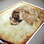 Print of a sheep’s head on an aged textured background