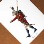 Print of a hare marching dressed in red British army uniform holding a musket on a white background