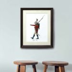 Original painting of a marching Hare dressed in British army uniform in a dark wood frame on a wall above stools